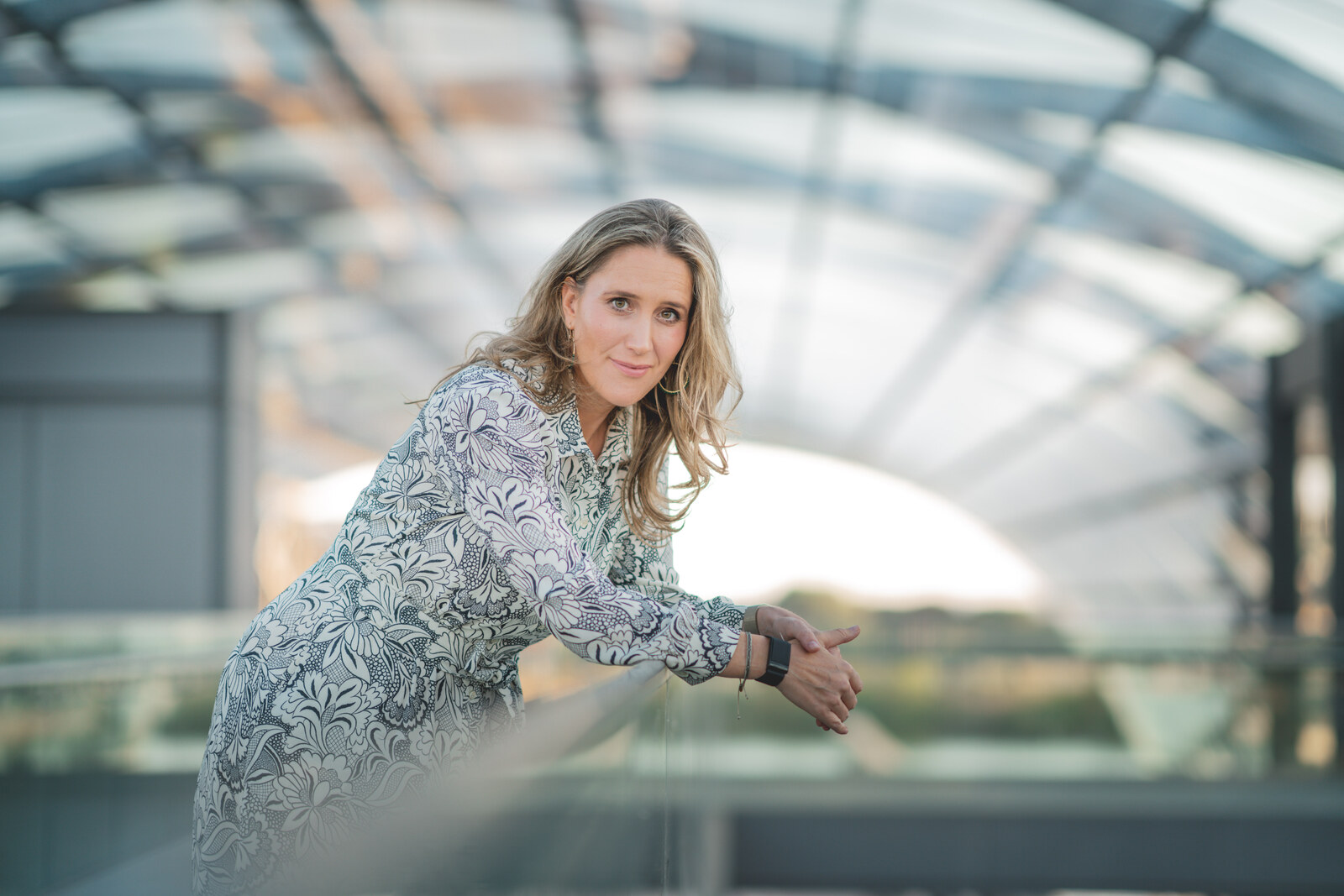 Svea Eckert under a glass roof, looking into the camera